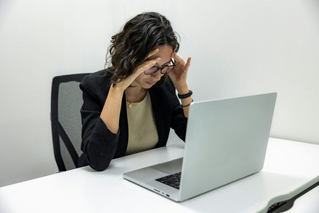 stressed office employee, staring at a laptop screen
