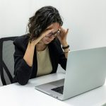 stressed office employee, staring at a laptop screen